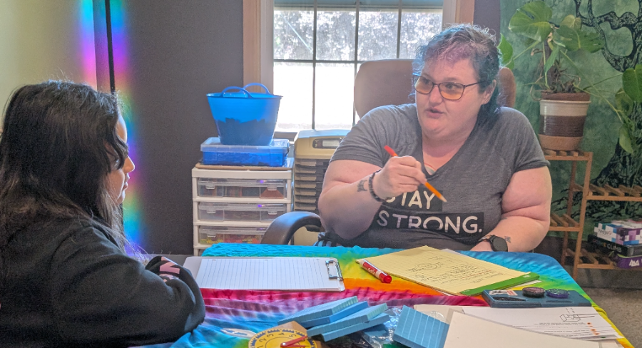 Dori Isakson talking through a problem with a student