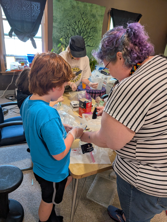 Kids designing their own sticker sheets at Sticker Lab